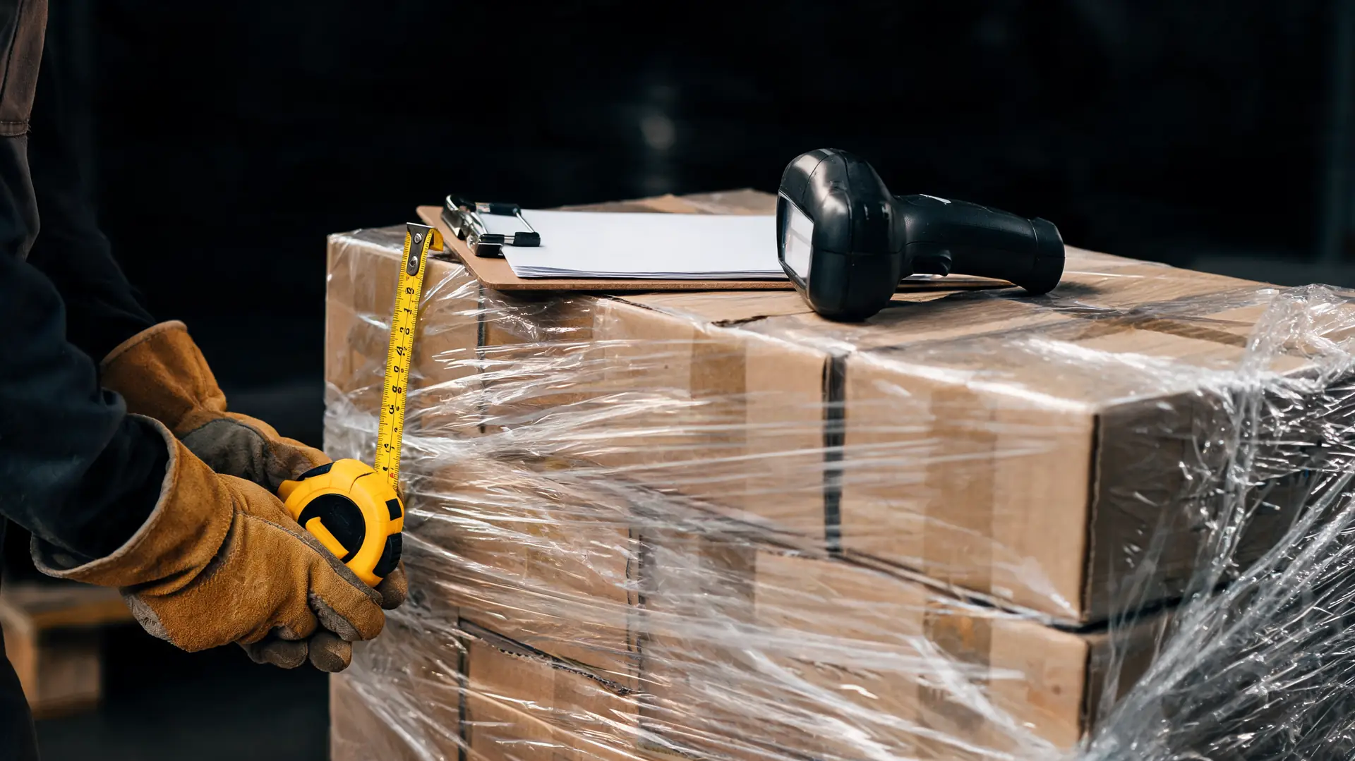 Measuring the height of a shrink-wrapped pallet with a tape measure